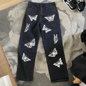 Black high waisted straight leg jeans with butterfly print.